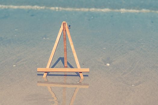 Wooden Easel photo stand tripod for photo with sea on background