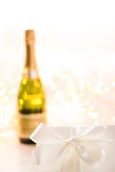 Romantic celebration, lifestyle and luxury present concept - The bottle of champagne and holiday gift box