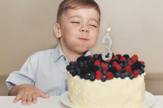 A boy blows out the candles for his birthday