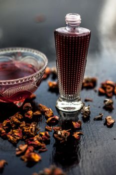 Face mask or pack on wooden surface consisting of rose water, lemon juice for acne and pimple. Vertical shot.