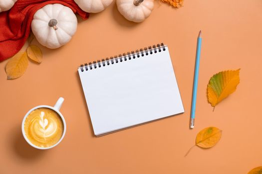 Blank notebook for text and pumpkins with autumn leaves. Autumn theme mock up.