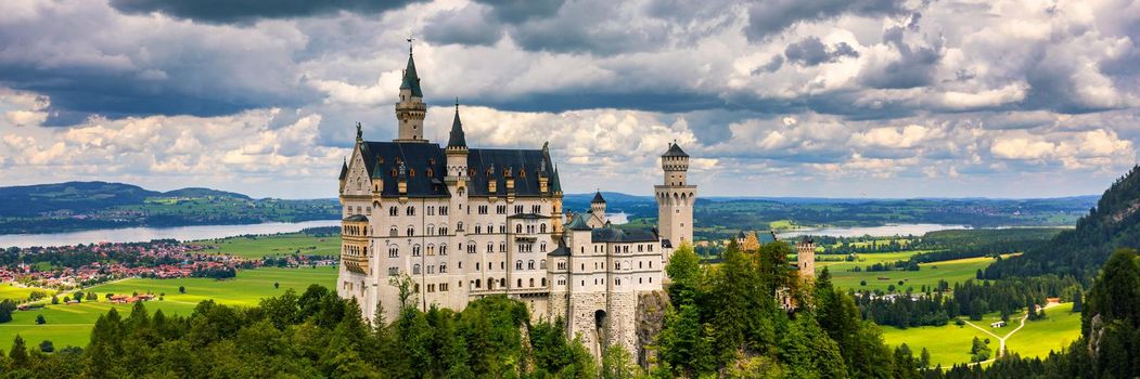 Famous Neuschwanstein Castle with scenic mountain landscape near Fussen, Bavaria, Germany. Neuschwanstein Castle in Hohenschwangau, Germany. 
