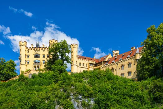 Hohenschwangau Castle near Fussen, Bavaria, Germany. Palace of king Ludwig II in Schwangau village. Schloss Hohenschwangau is landmark of German Alps. Hohenschwangau Castle and Alpsee in Schwangau.