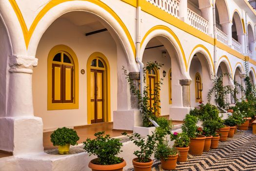 Sacred Monastery of Saint Archangel Michael the Panormitis, Symi, Greece. Monastery of Saint Archangel Michael, sacred place on coast of sea Aegean Symi island in Greece overlooking Panormitis port.
