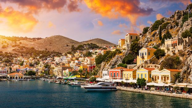 View of the beautiful greek island of Symi (Simi) with colourful houses and small boats. Greece, Symi island, view of the town of Symi (near Rhodes), Dodecanese.
