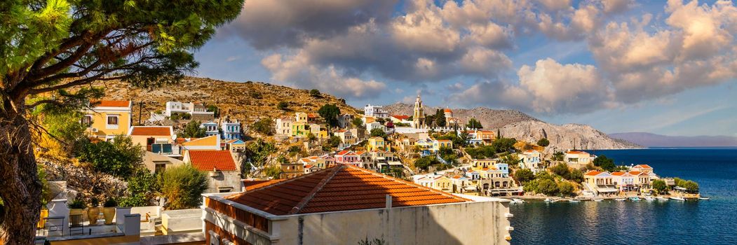 View of the beautiful greek island of Symi (Simi) with colourful houses and small boats. Greece, Symi island, view of the town of Symi (near Rhodes), Dodecanese.