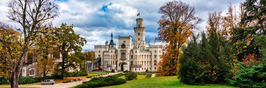 Castle Hluboka nad Vltavou is one of the most beautiful castles in Czech Republic. Castle Hluboka nad Vltavou in autumn with red foliage, Czechia. Colorful autumn view of Hluboka nad Vltavou castle.