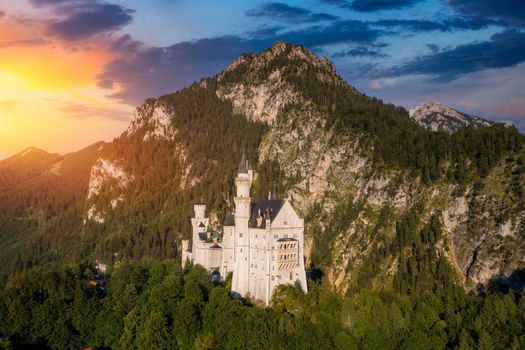Famous Neuschwanstein Castle with scenic mountain landscape near Fussen, Bavaria, Germany. Neuschwanstein Castle in Hohenschwangau, Germany. 