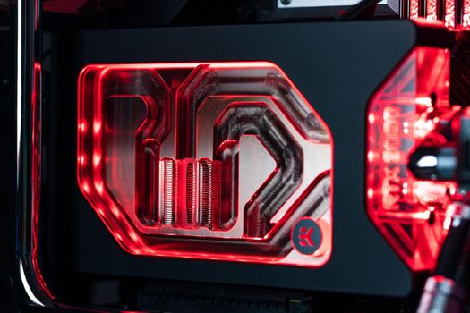 Prague, Czech Republic - 21 July 2021: Close-up of high performance Desktop PC and water cooling system with multicolored LED RGB light show status on working, interior on Computer PC Case and DIY
