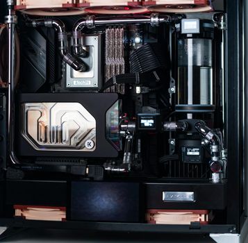 Prague, Czech Republic - 21 July 2021: Close-up of high performance Desktop PC and water cooling system with multicolored LED RGB light show status on working, interior on Computer PC Case and DIY