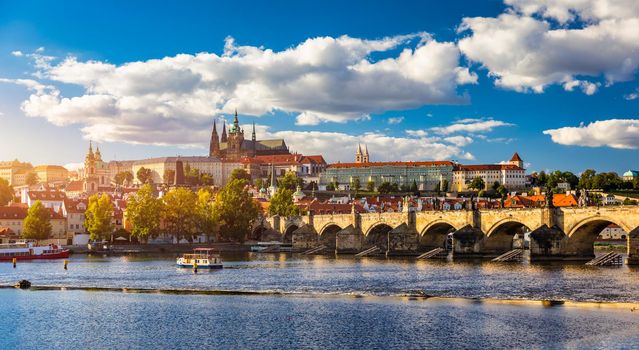 Prague Castle, Charles Bridge and boats on the Vltava river. View of Hradcany Prague Castle, Charles Bridge and a boats on the Vltava river in the capital of the Czechia. 