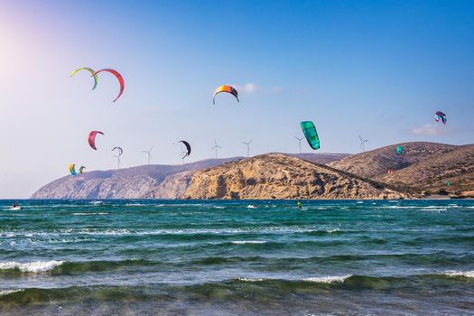 Surfers in Prasonisi Beach in Rhodes island, Greece. Kiteboarder kitesurfer athlete performing kitesurfing kiteboarding tricks. Prasonisi Beach is popular location for surfing. Greece