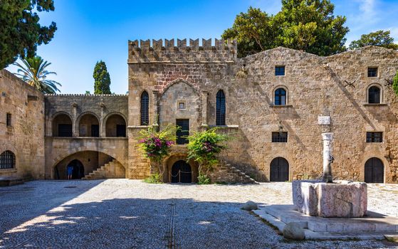 Medieval arched street in the old town of Rhodes, Greece. Rhodes old town in Rhodes island in Greece. Historical streets of old town Rhodes with flowers in Rhodes, Dodecanese, Greece