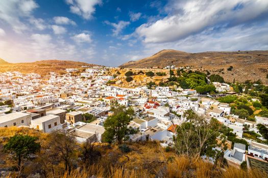 The famous and historical medieval village of Lindos on the Greek island of Rhodes with the Acropolis in the background. Lindos, Rhodes, Greece.