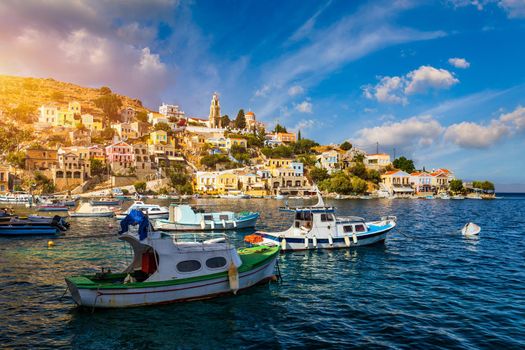 View on Symi (Simi) island harbor port, classical ship yachts, houses on island hills, Aegean Sea bay. Greece islands holidays vacation travel tours from Rhodos island. Symi, Greece,  Dodecanese.