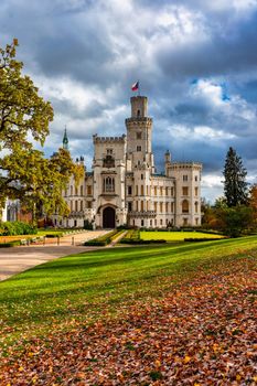 Castle Hluboka nad Vltavou is one of the most beautiful castles in Czech Republic. Castle Hluboka nad Vltavou in autumn with red foliage, Czechia. Colorful autumn view of Hluboka nad Vltavou castle.