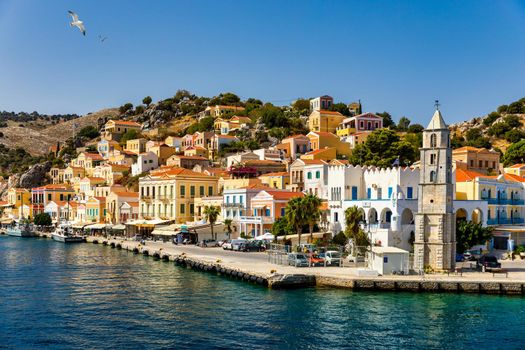 View of the beautiful greek island of Symi (Simi) with colourful houses and small boats. Greece, Symi island, view of the town of Symi (near Rhodes), Dodecanese.