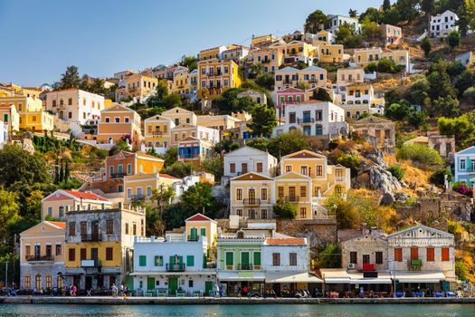 View of the beautiful greek island of Symi (Simi) with colourful houses and small boats. Greece, Symi island, view of the town of Symi (near Rhodes), Dodecanese.