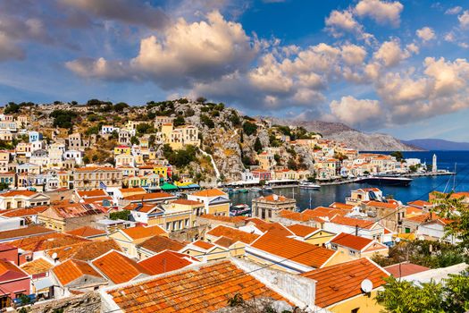 View of the beautiful greek island of Symi (Simi) with colourful houses and small boats. Greece, Symi island, view of the town of Symi (near Rhodes), Dodecanese.