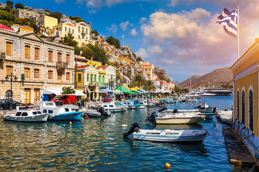 View of the beautiful greek island of Symi (Simi) with colourful houses and small boats. Greece, Symi island, view of the town of Symi (near Rhodes), Dodecanese.