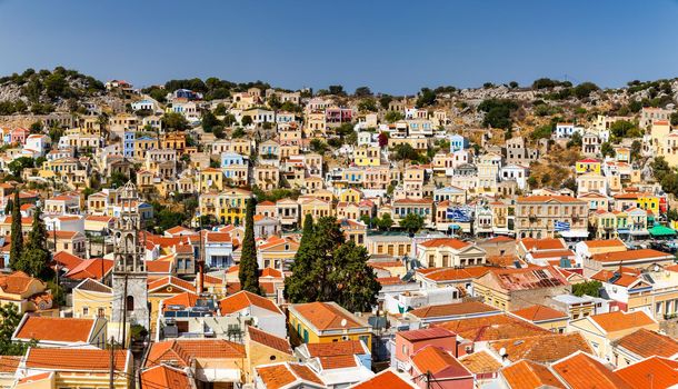 View of the beautiful greek island of Symi (Simi) with colourful houses and small boats. Greece, Symi island, view of the town of Symi (near Rhodes), Dodecanese.