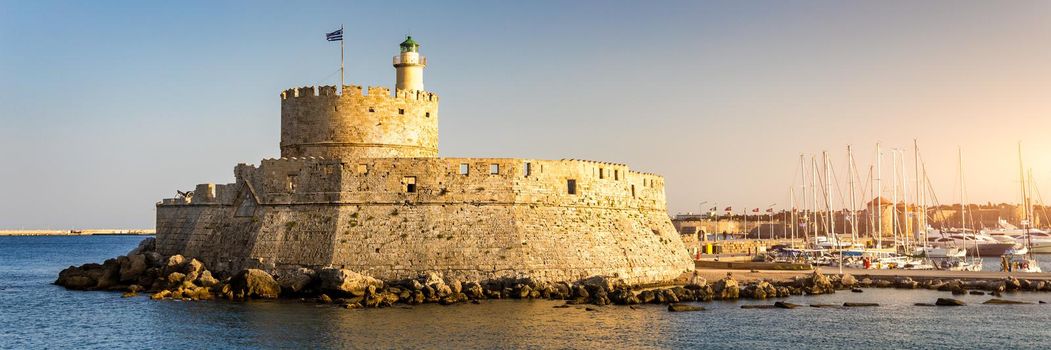 Panoramic view of Rhodes old town on Rhodes island, Greece. Saint Nicholas Fortress cityscape with sea port at. Travel destinations in Rhodes, Greece.