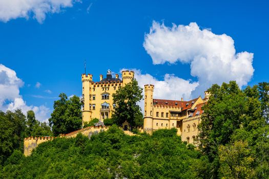 Hohenschwangau Castle near Fussen, Bavaria, Germany. Palace of king Ludwig II in Schwangau village. Schloss Hohenschwangau is landmark of German Alps. Hohenschwangau Castle and Alpsee in Schwangau.