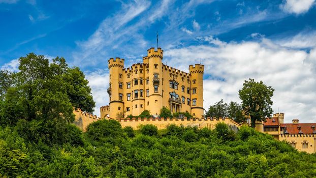 Hohenschwangau Castle near Fussen, Bavaria, Germany. Palace of king Ludwig II in Schwangau village. Schloss Hohenschwangau is landmark of German Alps. Hohenschwangau Castle and Alpsee in Schwangau.
