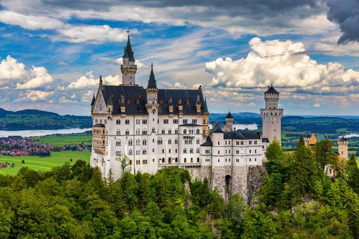 Famous Neuschwanstein Castle with scenic mountain landscape near Fussen, Bavaria, Germany. Neuschwanstein Castle in Hohenschwangau, Germany. 