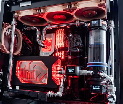 Prague, Czech Republic - 21 July 2021: Close-up of high performance Desktop PC and water cooling system with multicolored LED RGB light show status on working, interior on Computer PC Case and DIY