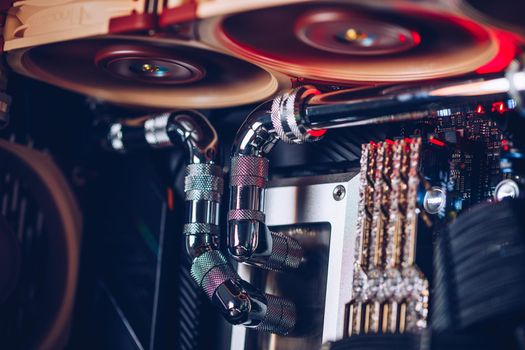 Prague, Czech Republic - 21 July 2021: Close-up of high performance Desktop PC and water cooling system with multicolored LED RGB light show status on working, interior on Computer PC Case and DIY