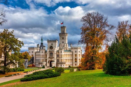 Castle Hluboka nad Vltavou is one of the most beautiful castles in Czech Republic. Castle Hluboka nad Vltavou in autumn with red foliage, Czechia. Colorful autumn view of Hluboka nad Vltavou castle.