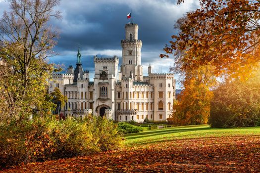 Castle Hluboka nad Vltavou is one of the most beautiful castles in Czech Republic. Castle Hluboka nad Vltavou in autumn with red foliage, Czechia. Colorful autumn view of Hluboka nad Vltavou castle.