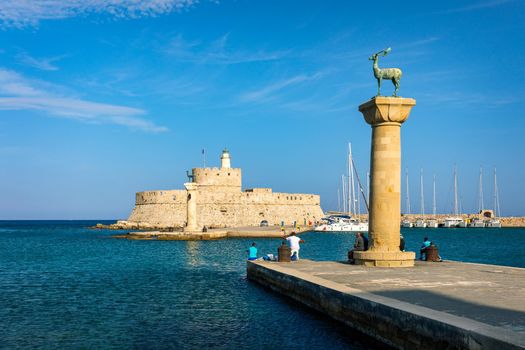 Mandraki port with deers statue, where The Colossus was standing and fort of St. Nicholas. Rhodes, Greece. Hirschkuh statue in the place of the Colossus of Rhodes, Rhodes, Greece