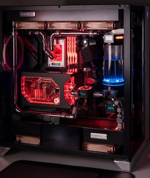 Prague, Czech Republic - 21 July 2021: Close-up of high performance Desktop PC and water cooling system with multicolored LED RGB light show status on working, interior on Computer PC Case and DIY