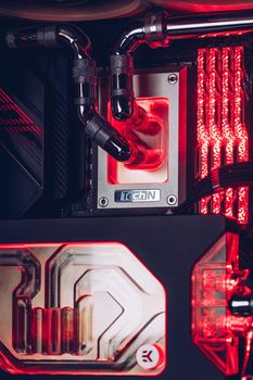 Prague, Czech Republic - 21 July 2021: Close-up of high performance Desktop PC and water cooling system with multicolored LED RGB light show status on working, interior on Computer PC Case and DIY