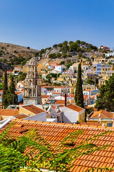 View of the beautiful greek island of Symi (Simi) with colourful houses and small boats. Greece, Symi island, view of the town of Symi (near Rhodes), Dodecanese.
