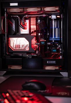 Prague, Czech Republic - 21 July 2021: Close-up of high performance Desktop PC and water cooling system with multicolored LED RGB light show status on working, interior on Computer PC Case and DIY