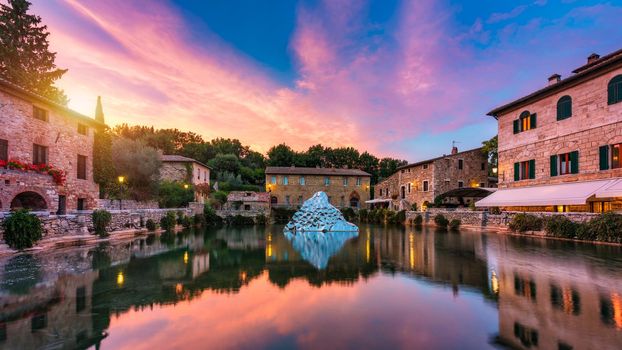 Thermal bath town of Bagno Vignoni, Italy during sunrise. Old thermal baths in the medieval village Bagno Vignoni, Tuscany, Italy. Medieval thermal baths in village Bagno Vignoni, Tuscany, Italy 
