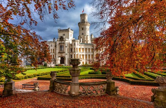 Castle Hluboka nad Vltavou is one of the most beautiful castles in Czech Republic. Castle Hluboka nad Vltavou in autumn with red foliage, Czechia. Colorful autumn view of Hluboka nad Vltavou castle.