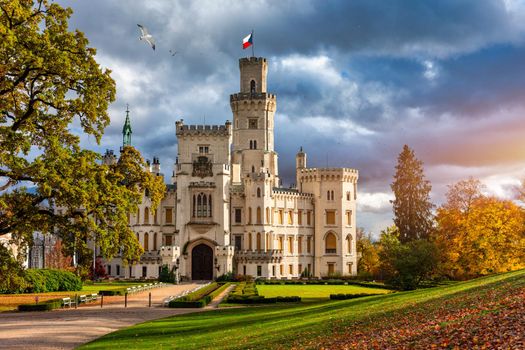 Castle Hluboka nad Vltavou is one of the most beautiful castles in Czech Republic. Castle Hluboka nad Vltavou in autumn with red foliage, Czechia. Colorful autumn view of Hluboka nad Vltavou castle.