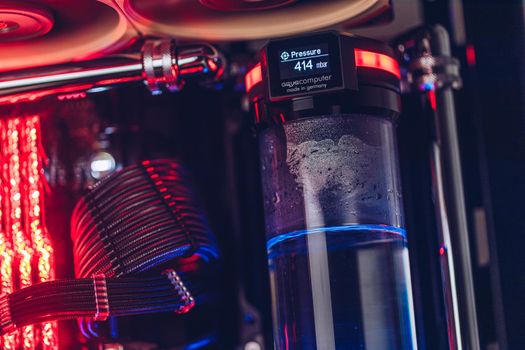 Prague, Czech Republic - 21 July 2021: Close-up of high performance Desktop PC and water cooling system with multicolored LED RGB light show status on working, interior on Computer PC Case and DIY