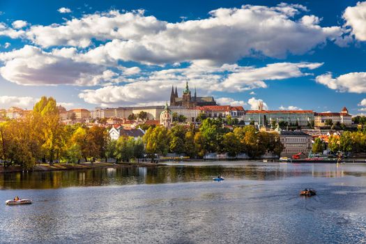 Prague Castle, Charles Bridge and boats on the Vltava river. View of Hradcany Prague Castle, Charles Bridge and a boats on the Vltava river in the capital of the Czechia. 