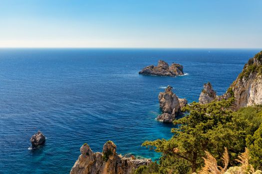 Picturesque seaside of Paleokastritsa, Corfu, Greece. Beautiful bay in Paleokastritsa in Corfu island, Greece. Panoramic view of Palaiokastritsa, boats and beach Corfu, Greece