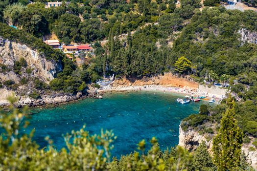 Picturesque seaside of Paleokastritsa, Corfu, Greece. Beautiful bay in Paleokastritsa in Corfu island, Greece. Panoramic view of Palaiokastritsa, boats and beach Corfu, Greece