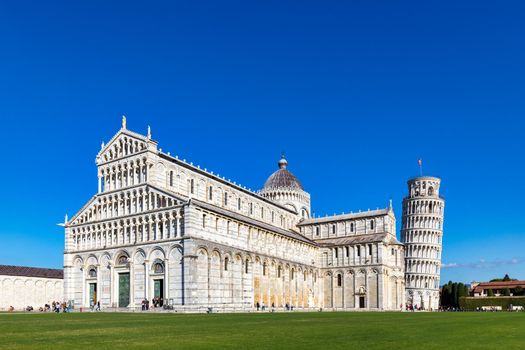 Pisa Cathedral and the Leaning Tower in a sunny day in Pisa, Italy. Pisa Cathedral with Leaning Tower of Pisa on Piazza dei Miracoli in Pisa, Tuscany, Italy.