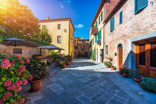Cozy street decorated with colorful flowers, Pienza, Tuscany, Italy, Europe. Narrow street in the charming town of Pienza in Tuscany. Beautiful streets of the small and historic village Pienza, Italy