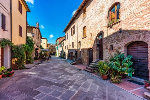 Cozy street decorated with colorful flowers, Pienza, Tuscany, Italy, Europe. Narrow street in the charming town of Pienza in Tuscany. Beautiful streets of the small and historic village Pienza, Italy