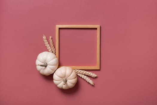 Decorative pumpkins and wooden frame for text, autumn themed blank top view, flat lay.