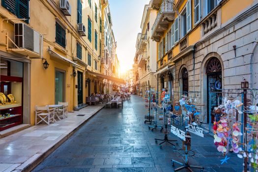 Street view of Kerkyra, capital of Corfu island, Greece. View of Kerkyra with beautiful buildings during summer sunny day. Corfu island, Greece. 